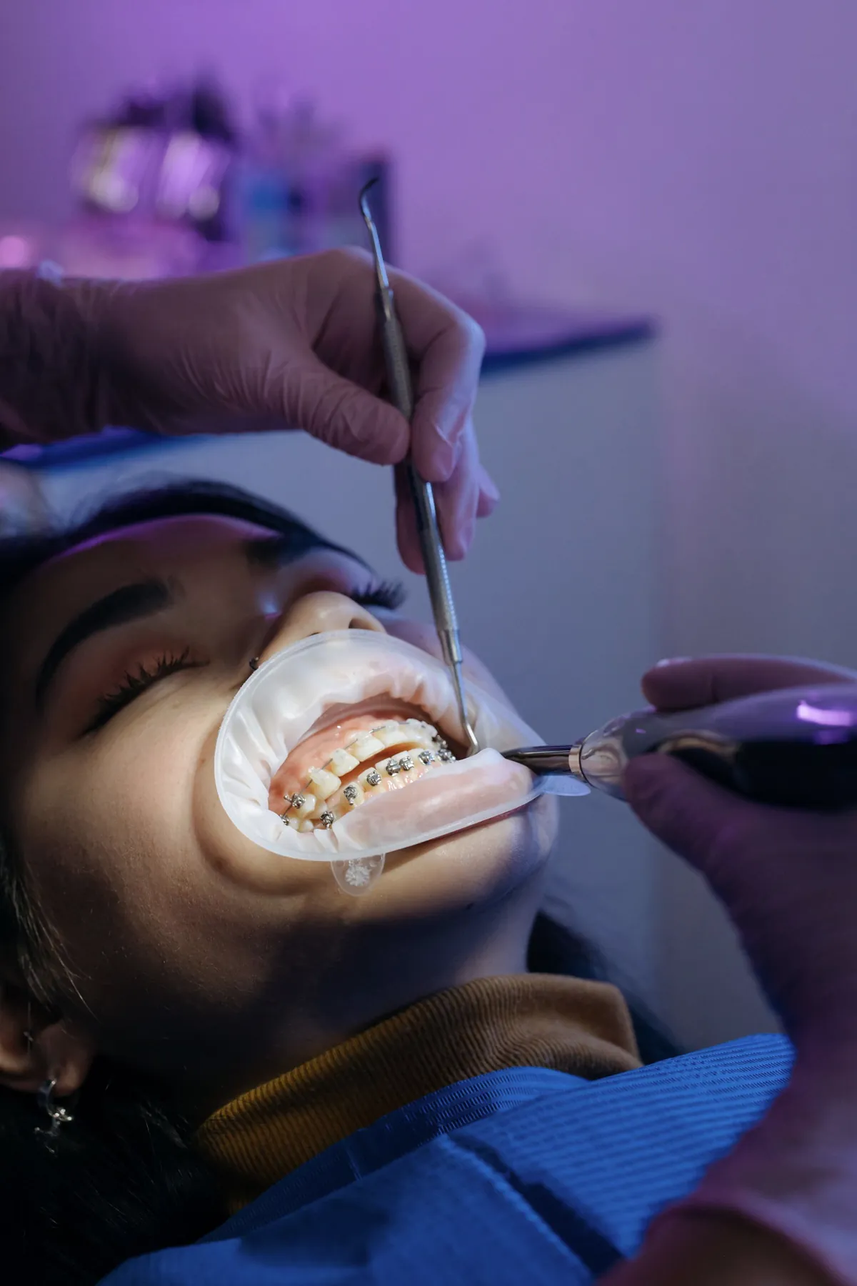 Patient receiving orthodontic treatment while wearing braces