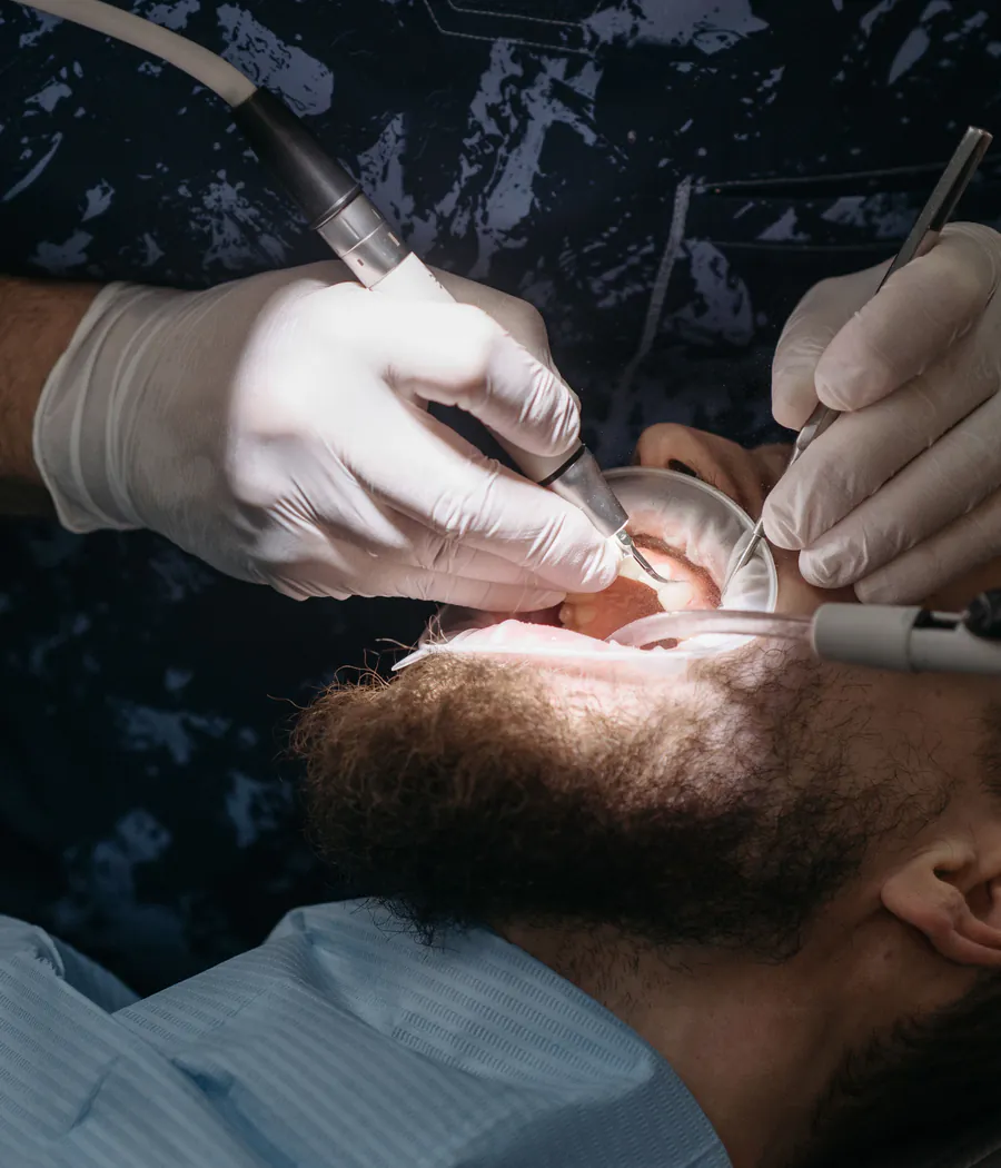 Dentist carrying out a routine examination and cleaning in a treatment room