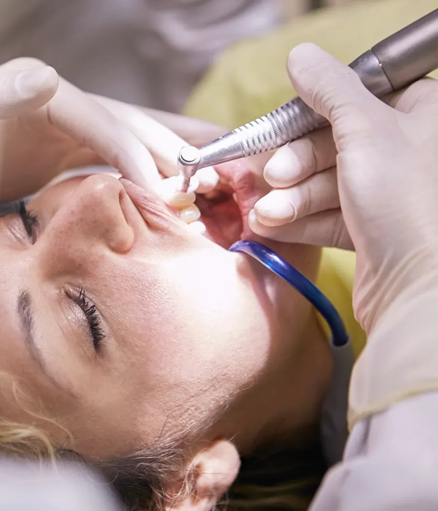 Dentist carefully treating a tooth during root canal therapy